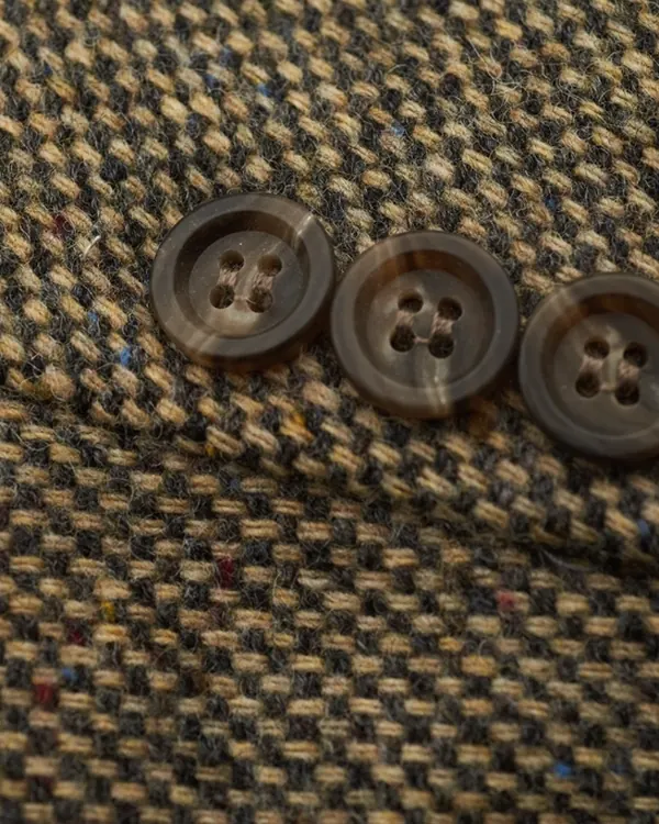 Tweed with the original buttons. Nobody makes these any more.